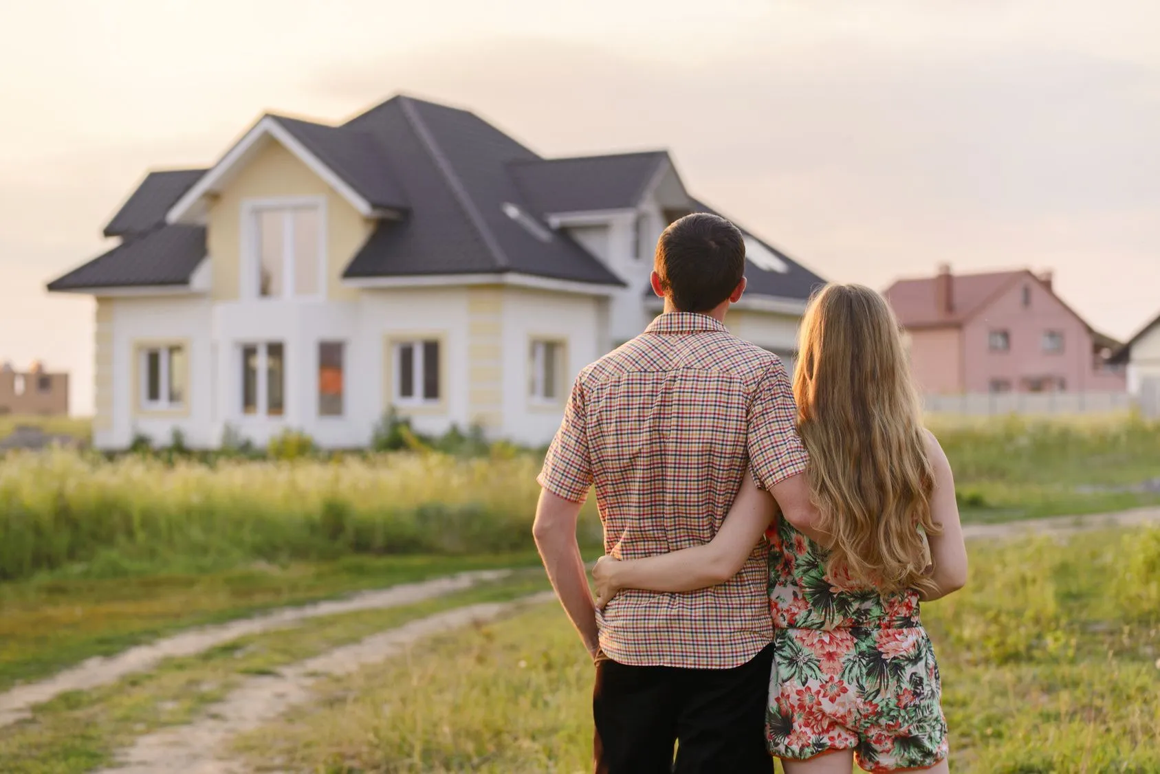 Person holding a model house